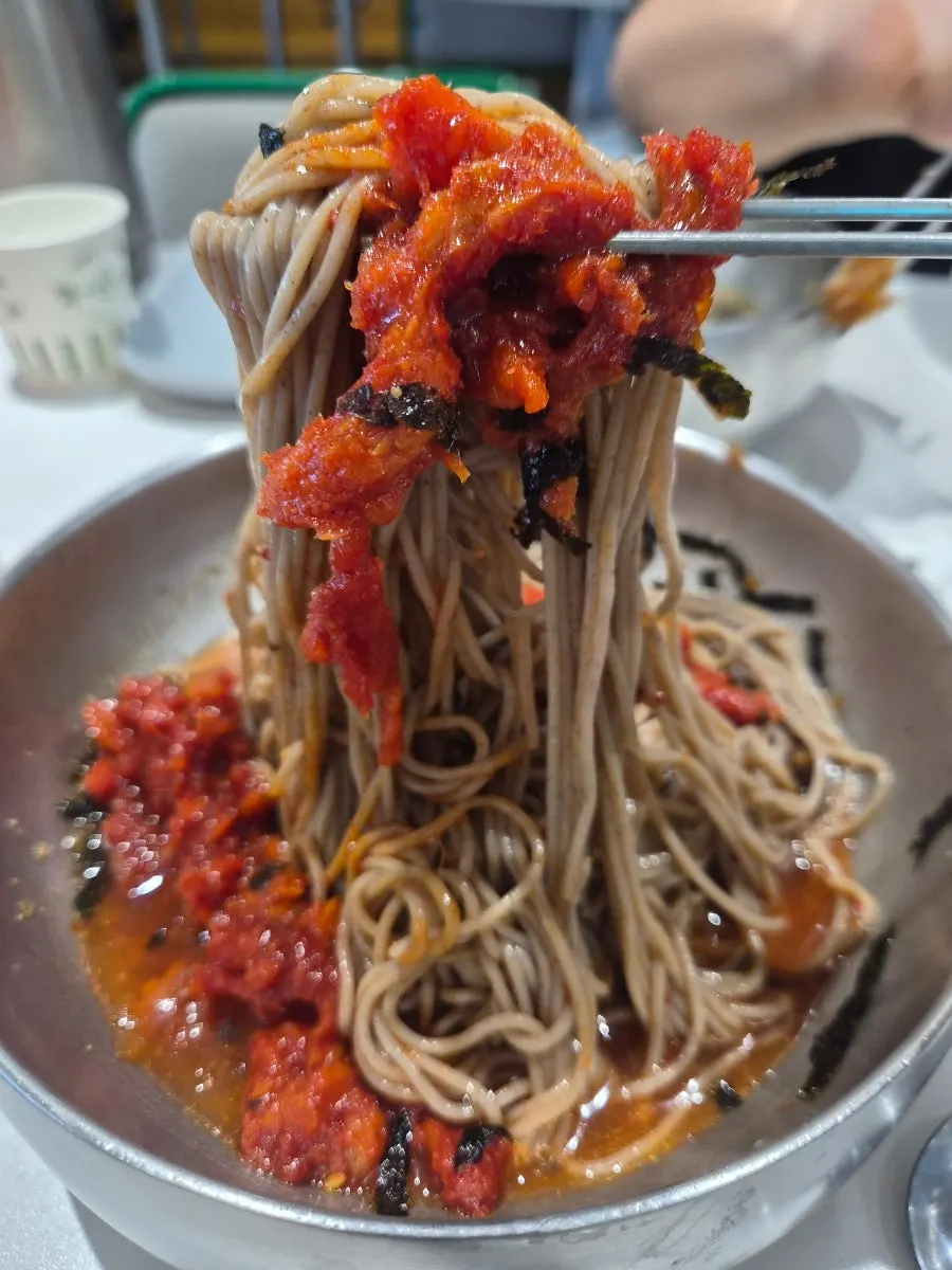 Sashimi makguksu piled high with pollack sashimi