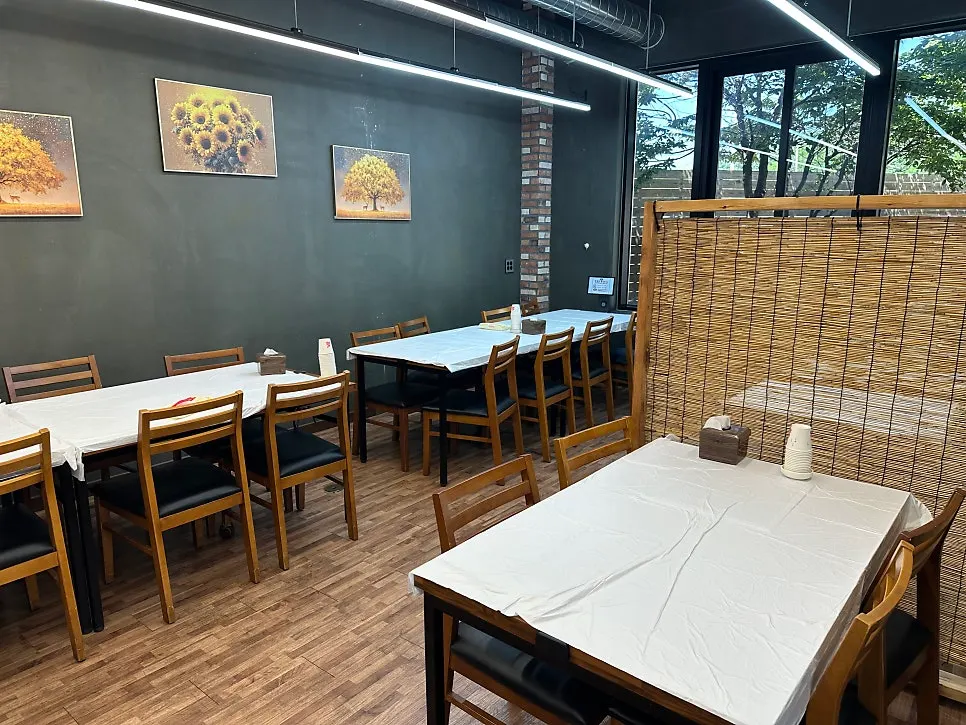 Dining hall seating with wide gaps between tables at Saimdang Bueok