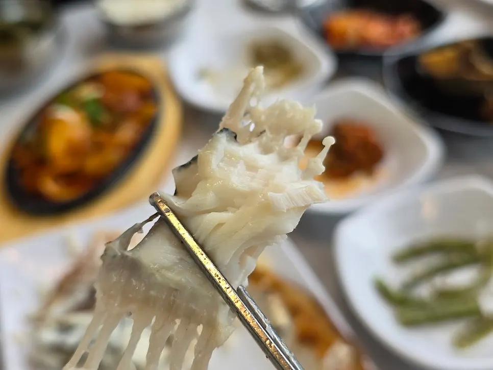 Flaked flounder meat alongside sundubu