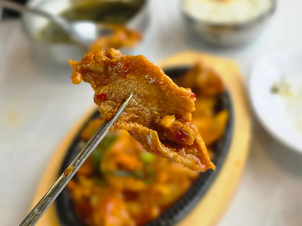 A thick piece of meat visible in the jeyuk bokkeum