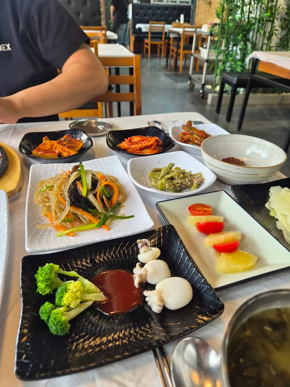 Plates of japchae and namul side dishes