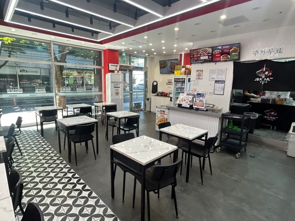 Dining hall interior with white marble tables and black chairs