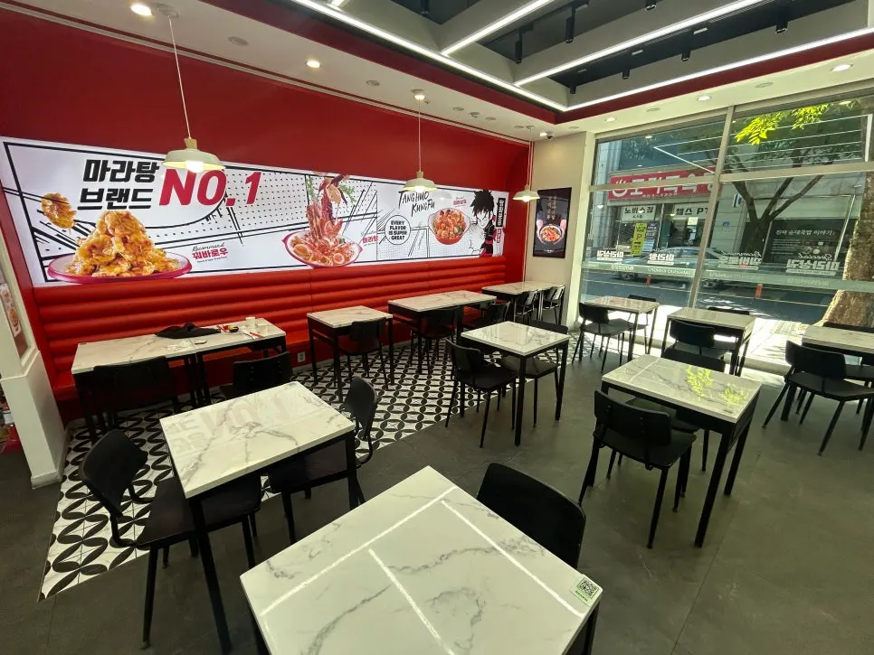 Sofa seating along the wall with illustrated menu photos