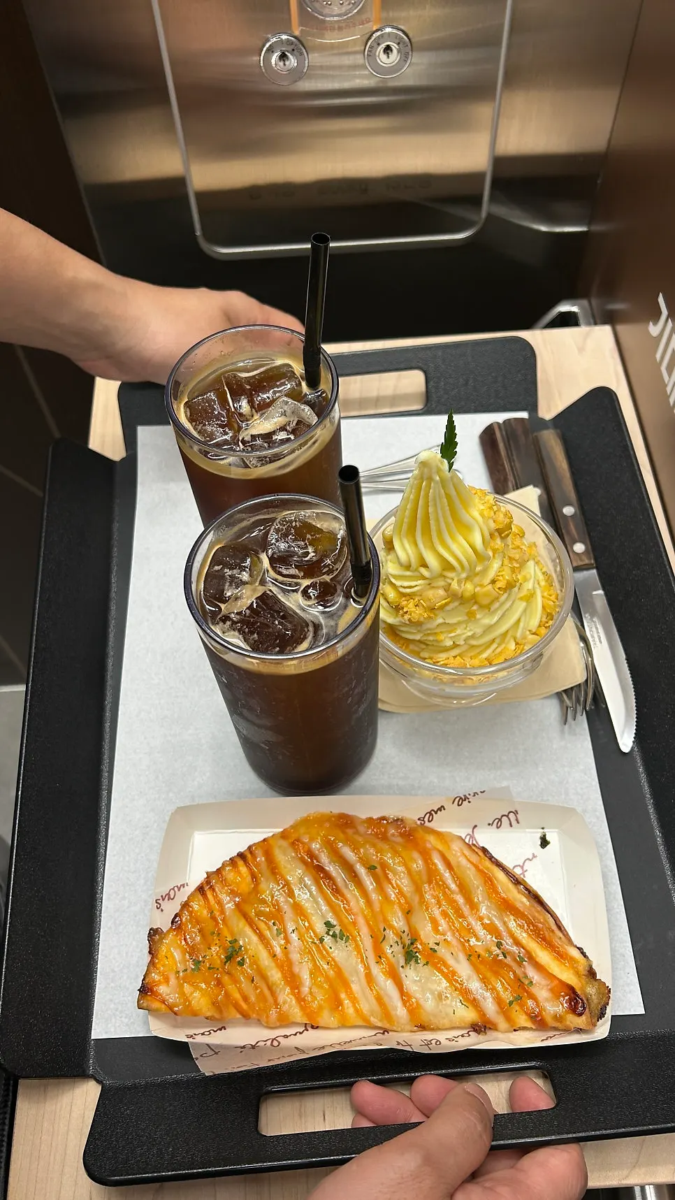 Two iced Americanos and dessert