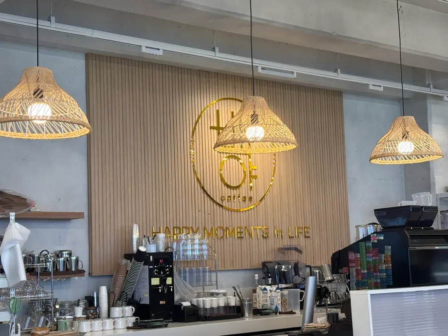 Indoor seating at Baegya Coffee with an ocean-view window