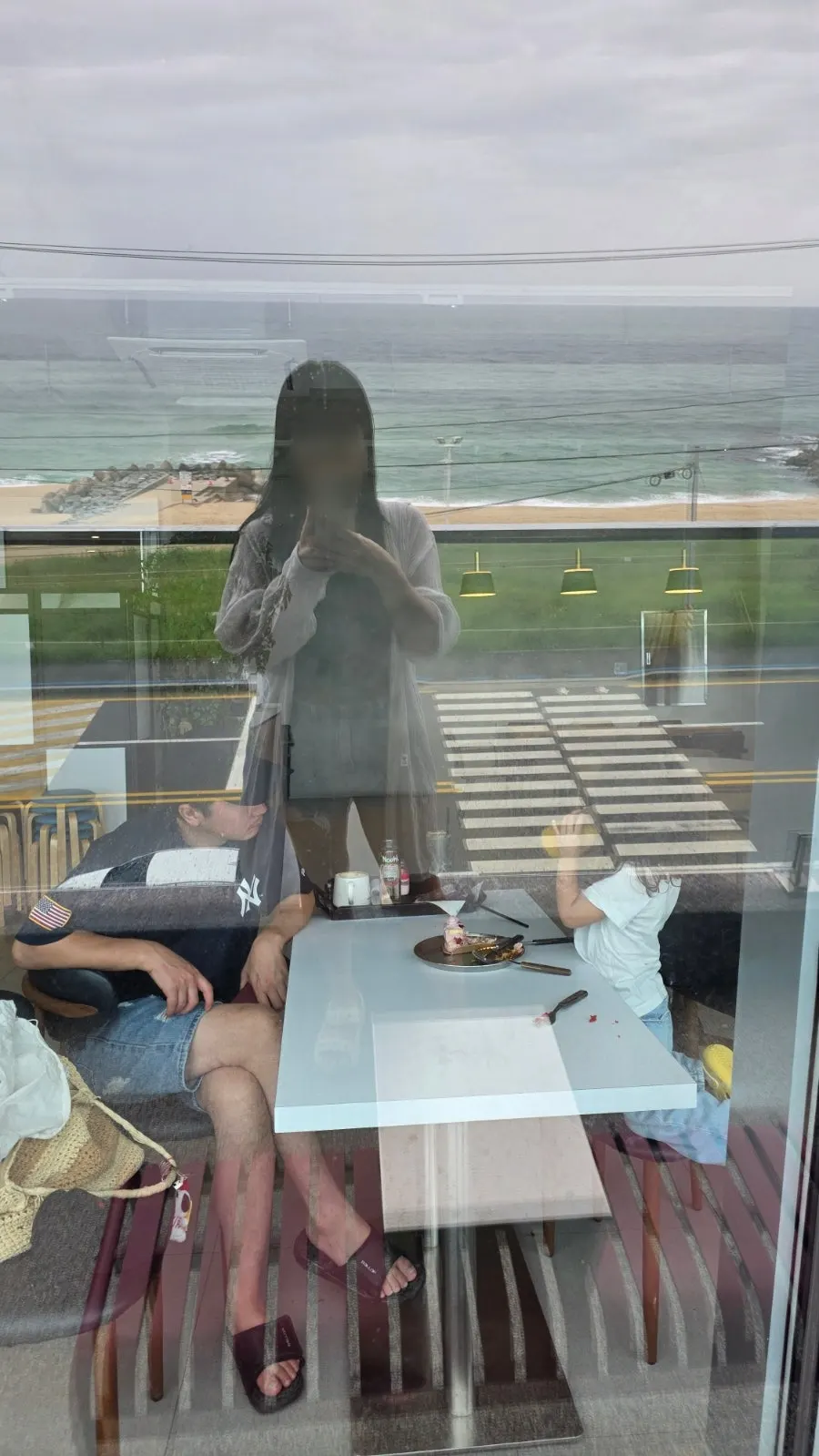 Indoor seat at Baegya Coffee looking out at the rainy sea