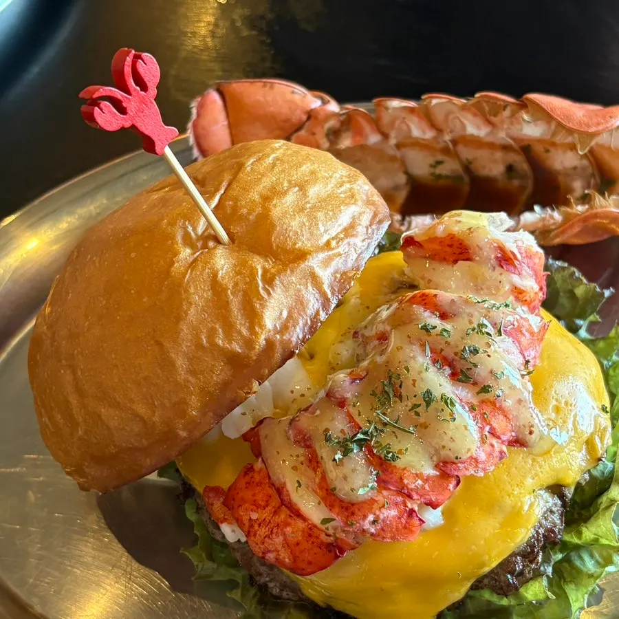 Burger with lobster tail and vegetables