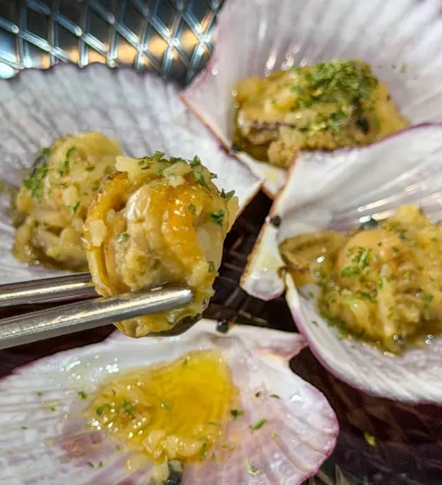Butter-grilled scallops included in the table setting