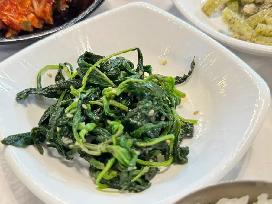 Spicy stir-fried pork eaten with a cabbage wrap