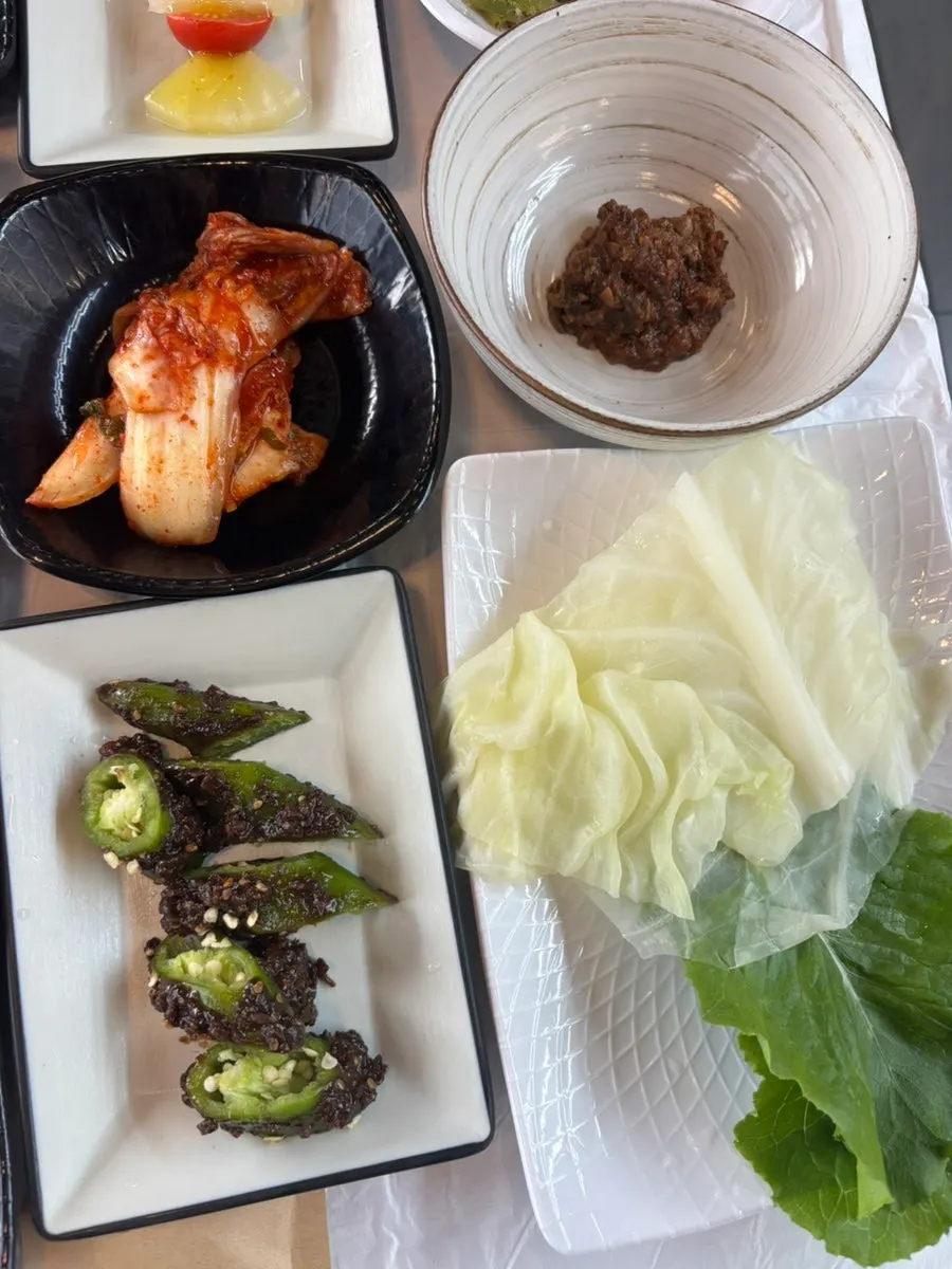 Various side dishes including braised tofu and anchovies