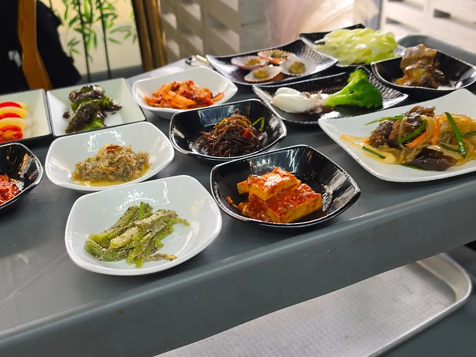 Neatly prepared side dishes being brought out on a cart