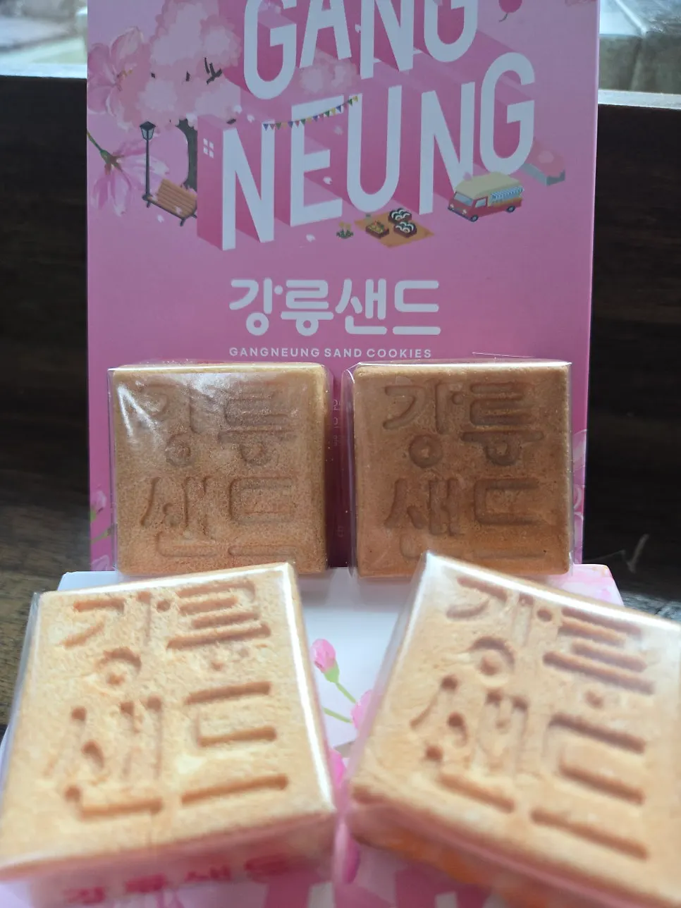 Individually wrapped Gangneung Sand cookies arranged in two rows