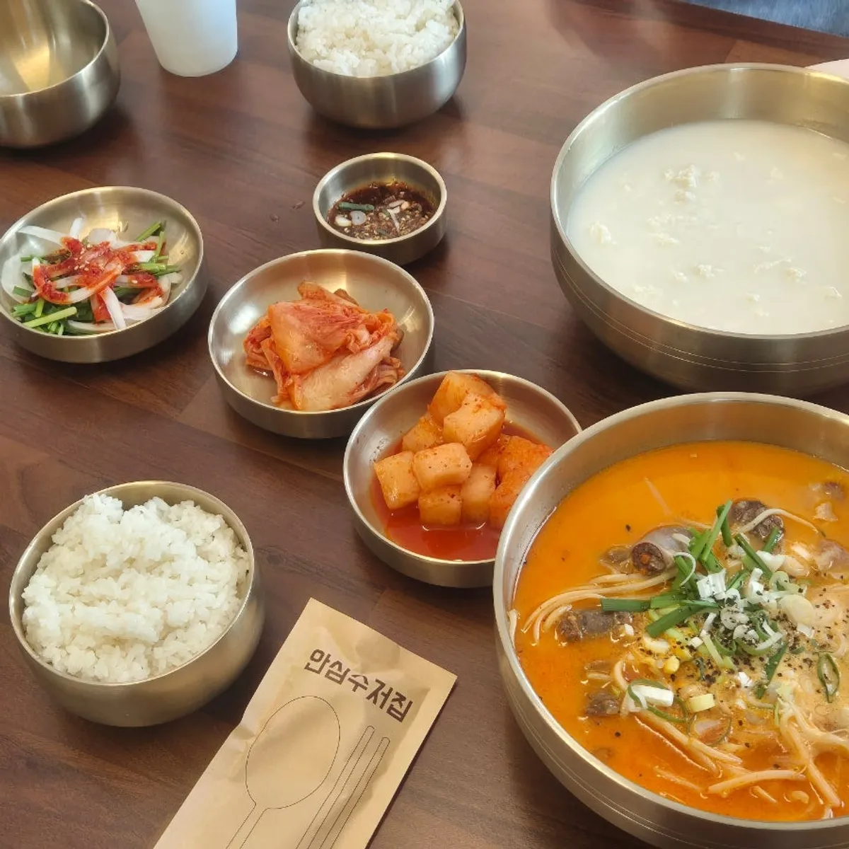 A table set with gukbap, rice, and side dishes
