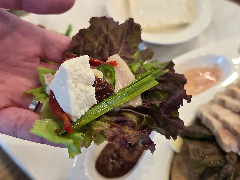 Perilla leaf wrap topped with tofu and bossam