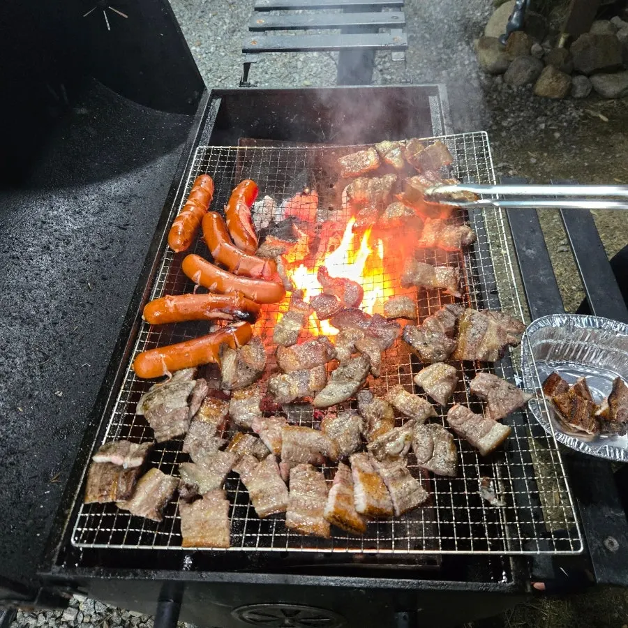 Grilling meat at the Yeongjin-gil 51 barbecue zone