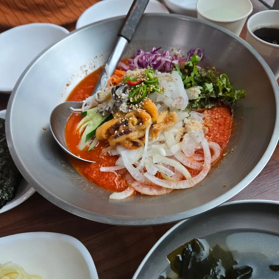 A bowl of assorted mulhoe with fine ice floating on top