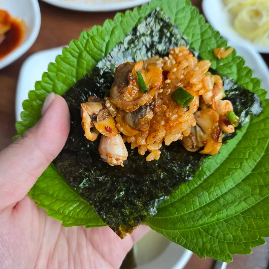 Close-up of bibimbap piled high with cockles
