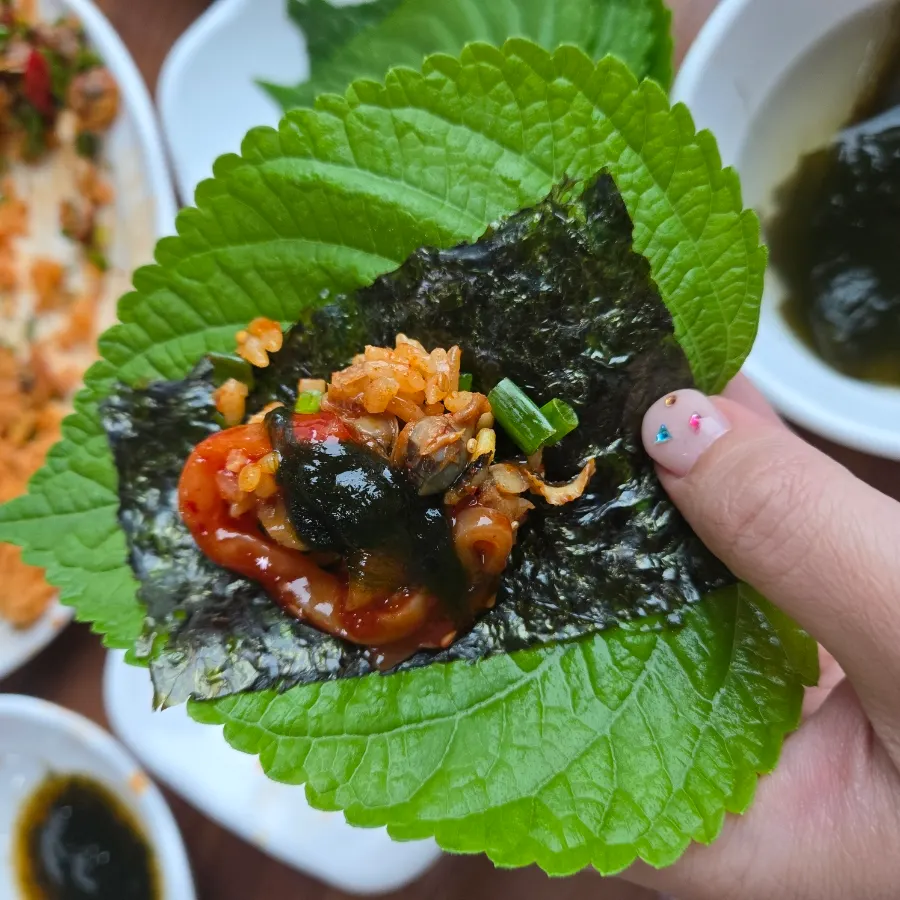 Salted squid jeotgal added on top of the rice