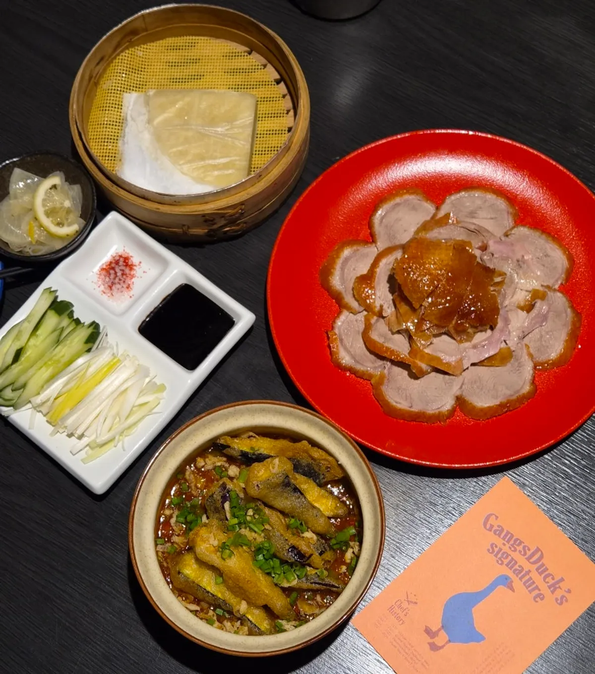 Weekday lunch table with Peking duck and spicy eggplant rice bowl at Gang's Duck