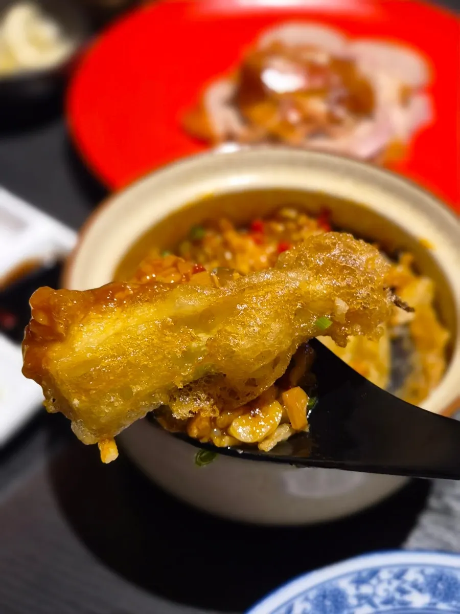 Crispy fried eggplant over spicy sauce rice