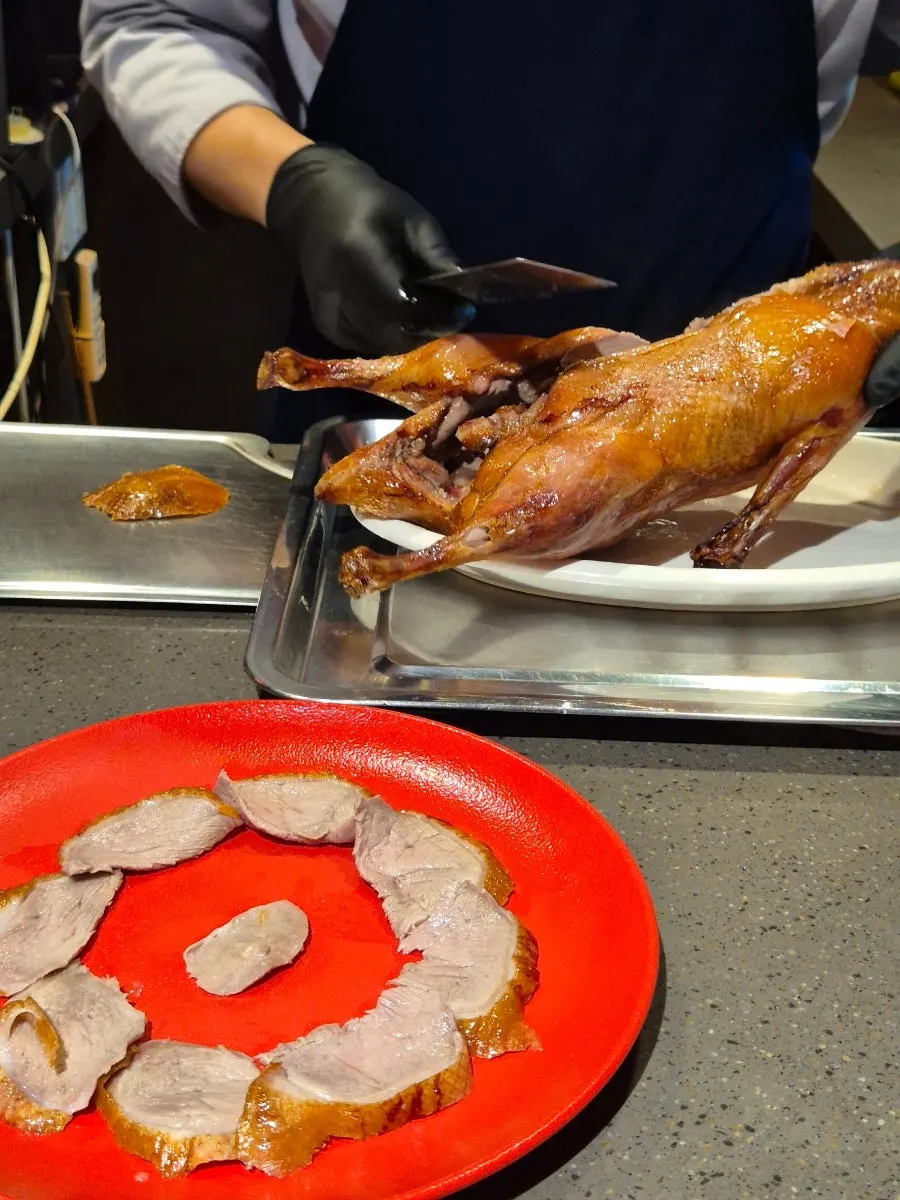 Chef trimming the duck at the open kitchen