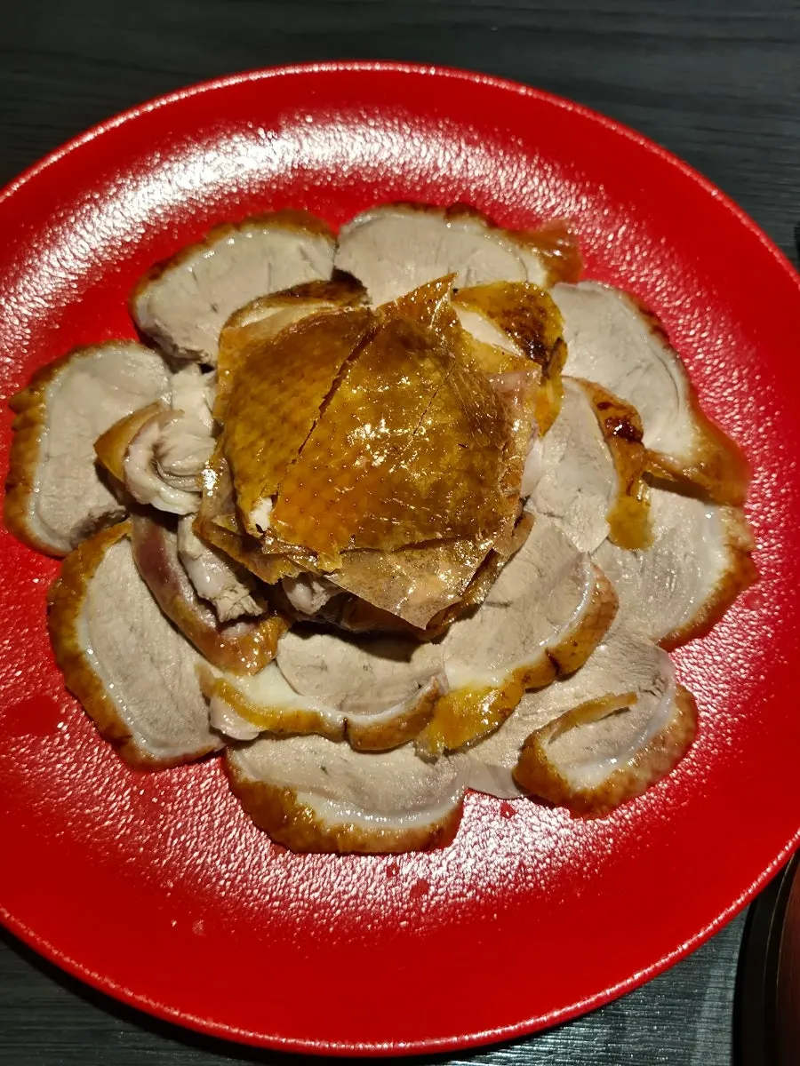 Trimmed Peking duck meat served on a plate