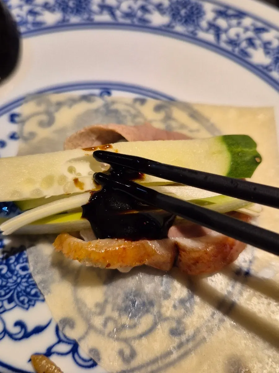 Crispy duck skin dipped in pink salt
