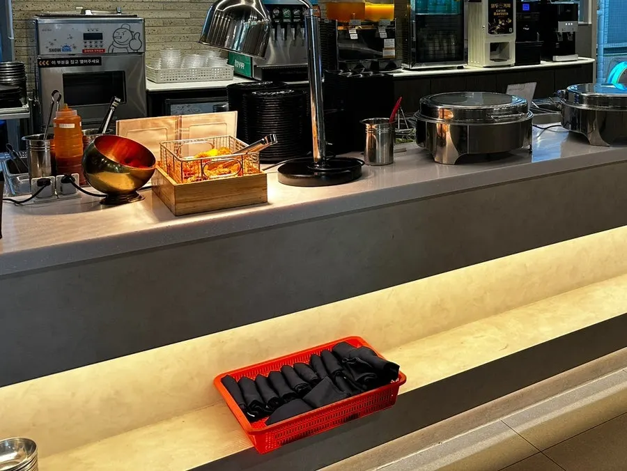 Aprons stored beneath the self-serve bar