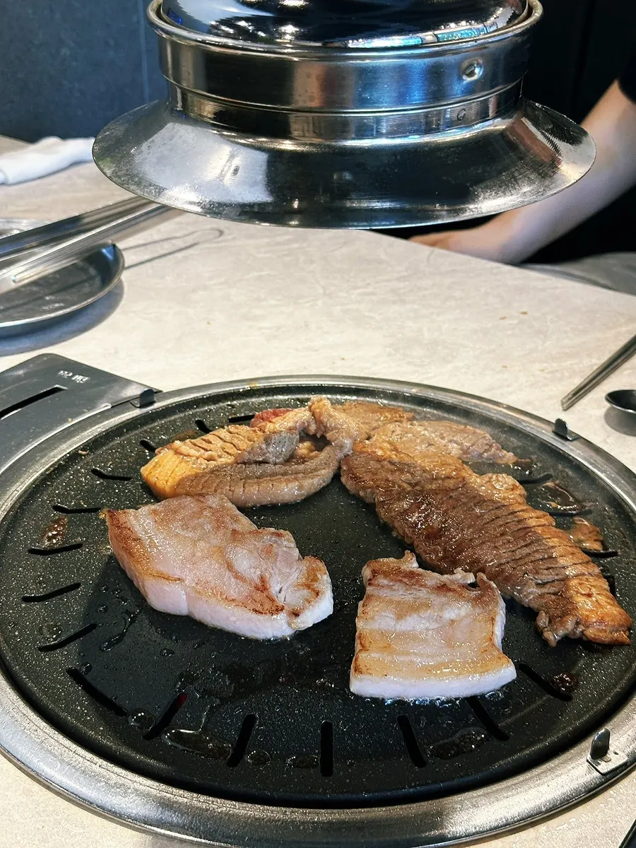 Pork belly and pork rib grilling together on the pan