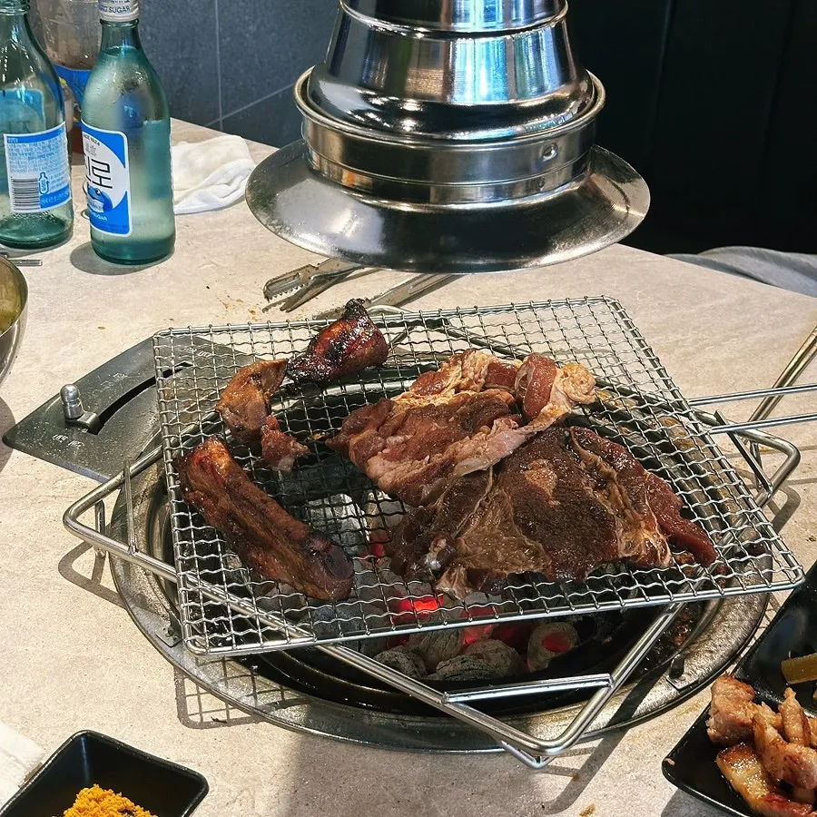Three bottles of soju stacked on the table