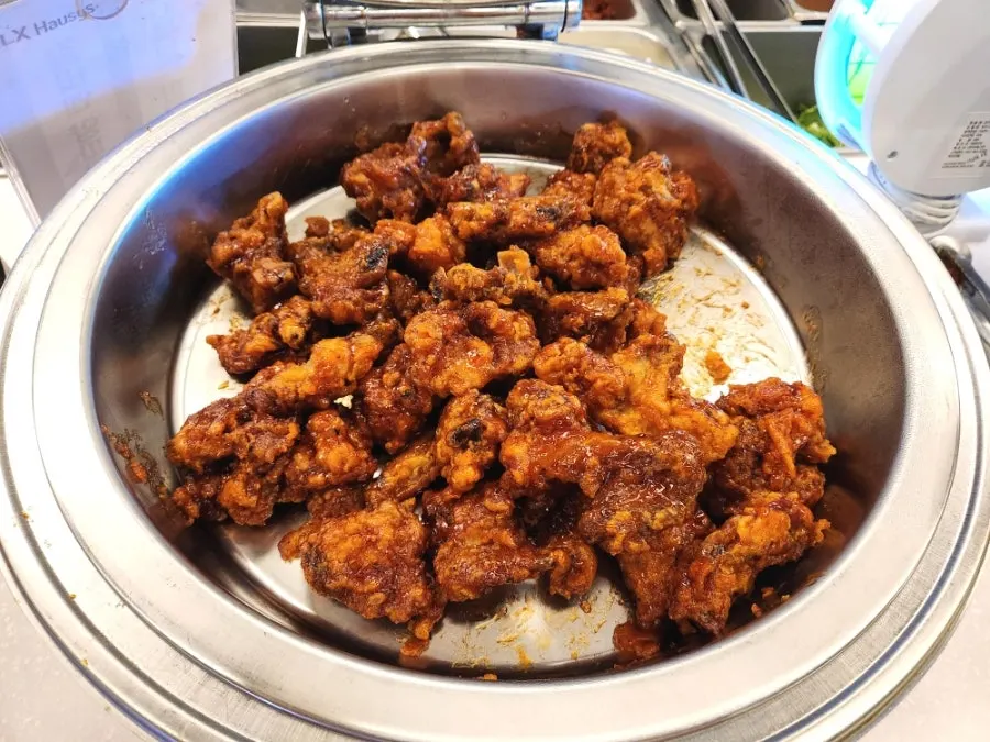 Seasoned fried chicken and tteokbokki brought to the table