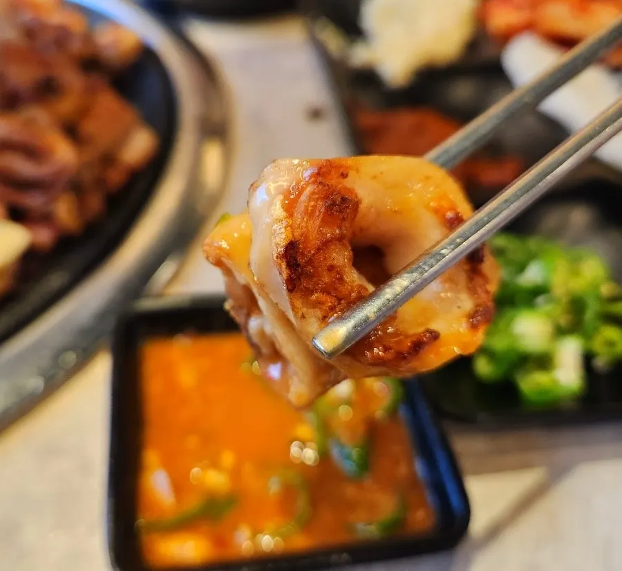 A piece of makchang dipped in makchang sauce