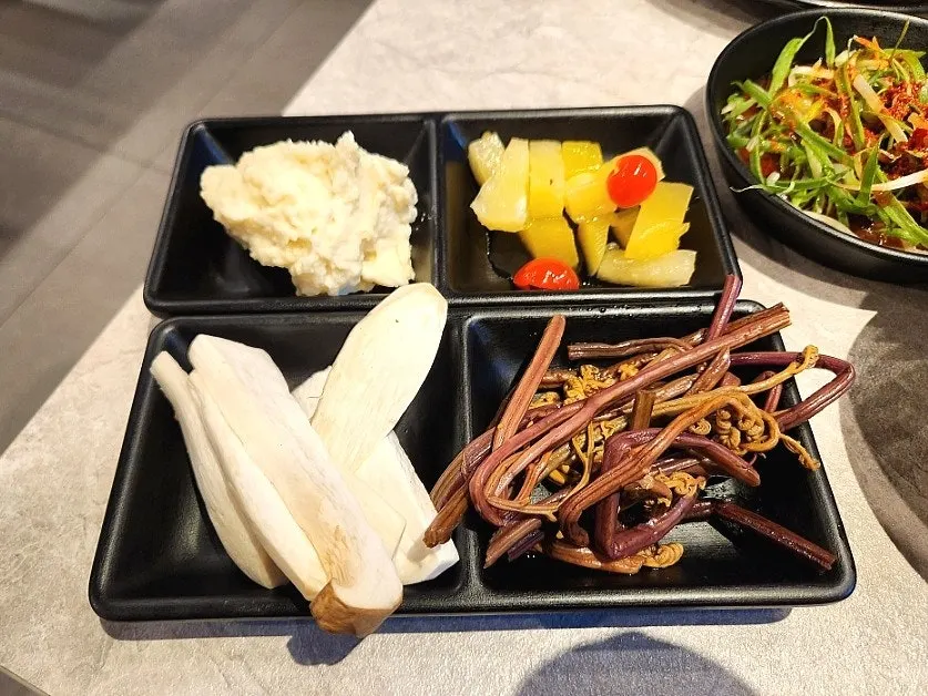 Two thick-cut pieces of raw pork belly