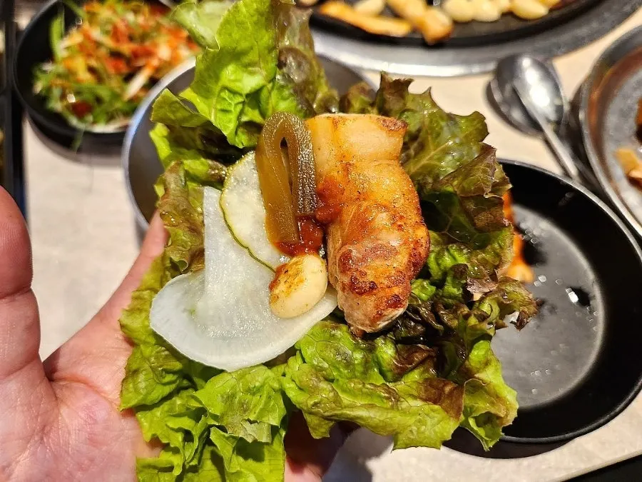 A piece of pork belly dipped in salt and curry powder