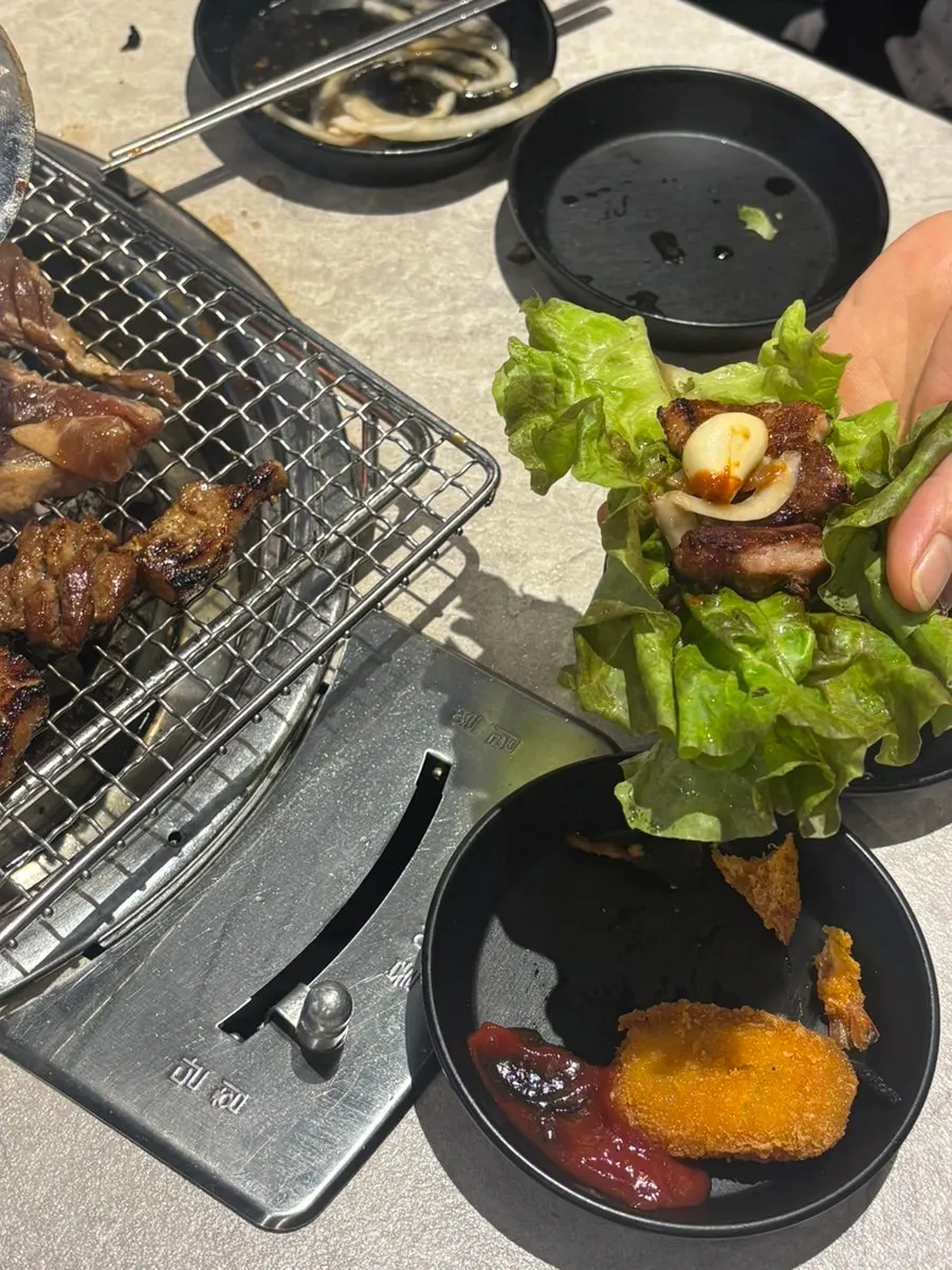 Table spread with naengmyeon alongside the meat