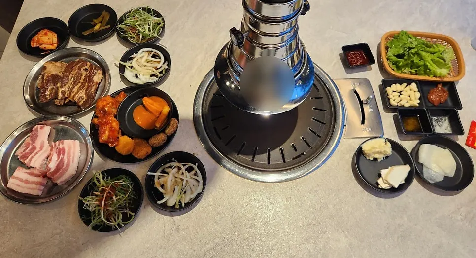 Food and side dishes displayed at the Gankeun Galbi self-bar