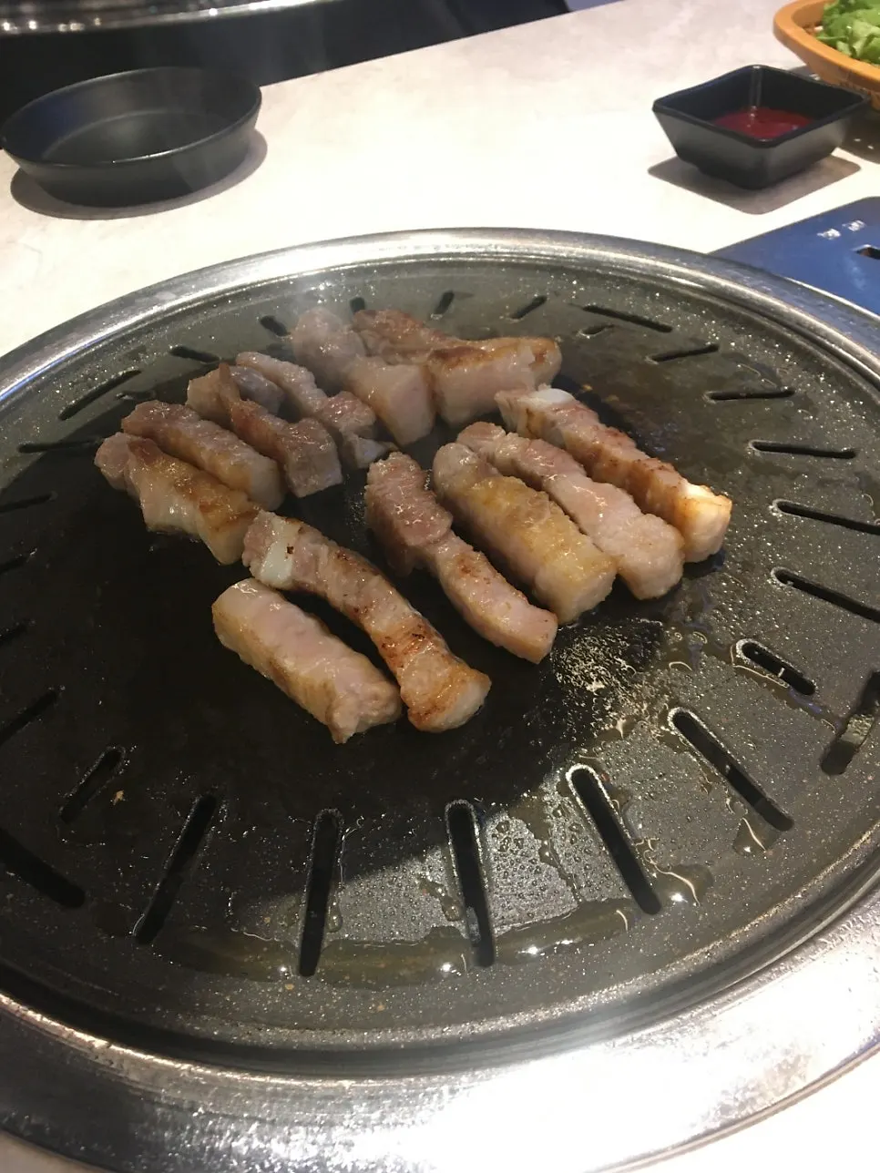 Domestic pork belly grilling to golden brown on the pan