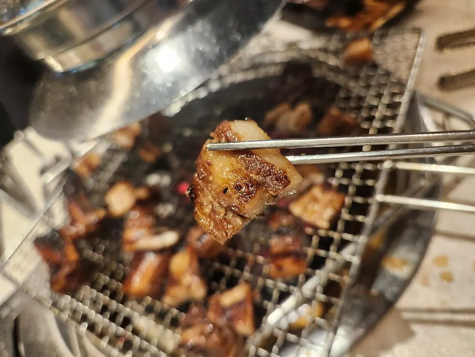 Pork ribs turned while grilling