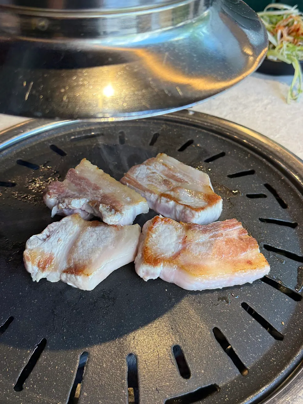 Close-up of grilling pork belly