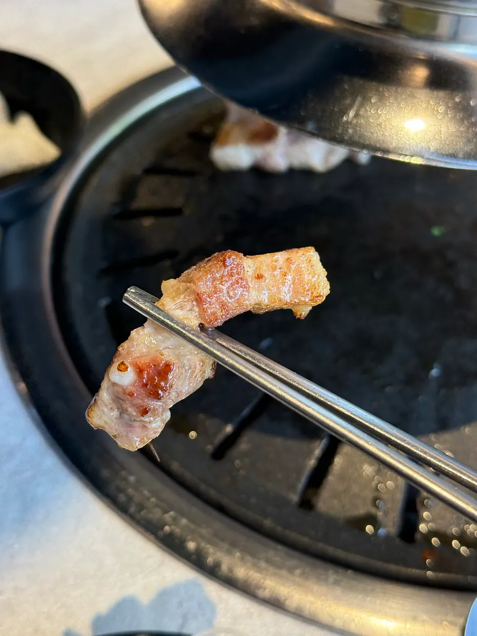 A piece of pork belly dipped in salt