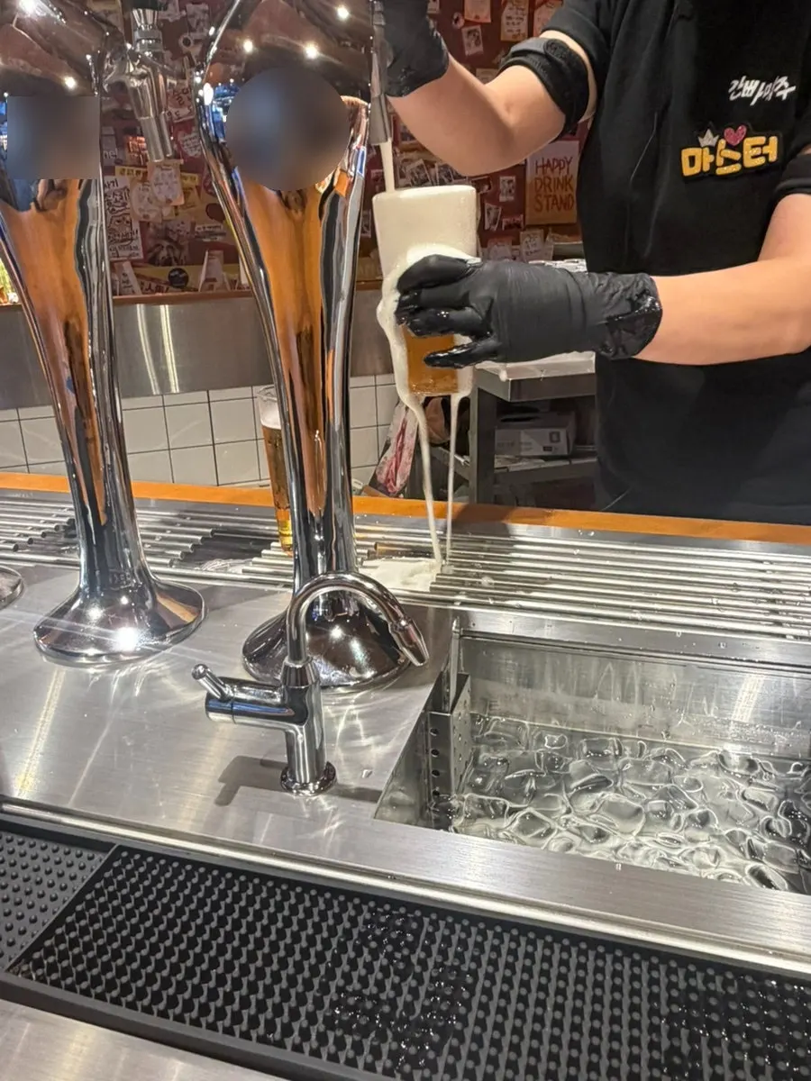 Staff member pouring draft beer at the counter