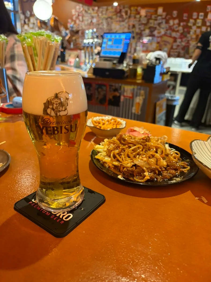 An additional glass of Ebisu draft beer ordered