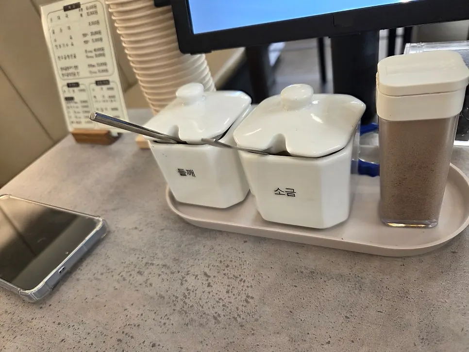 Salt, perilla seeds, and pepper set on the table