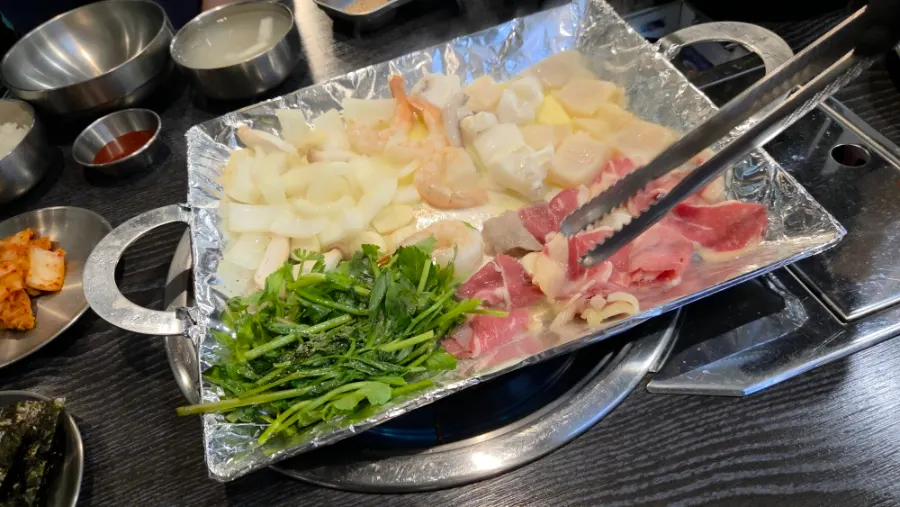 Beef brisket, scallops, shrimp and cuttlefish grilling together