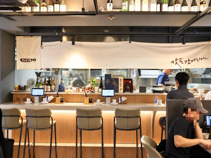 Bar counter seating facing the open kitchen
