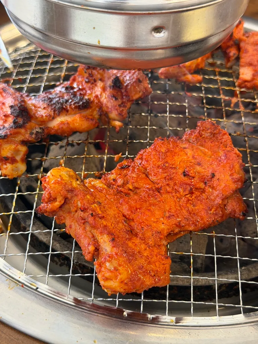 Seasoned dakgalbi grilled over charcoal