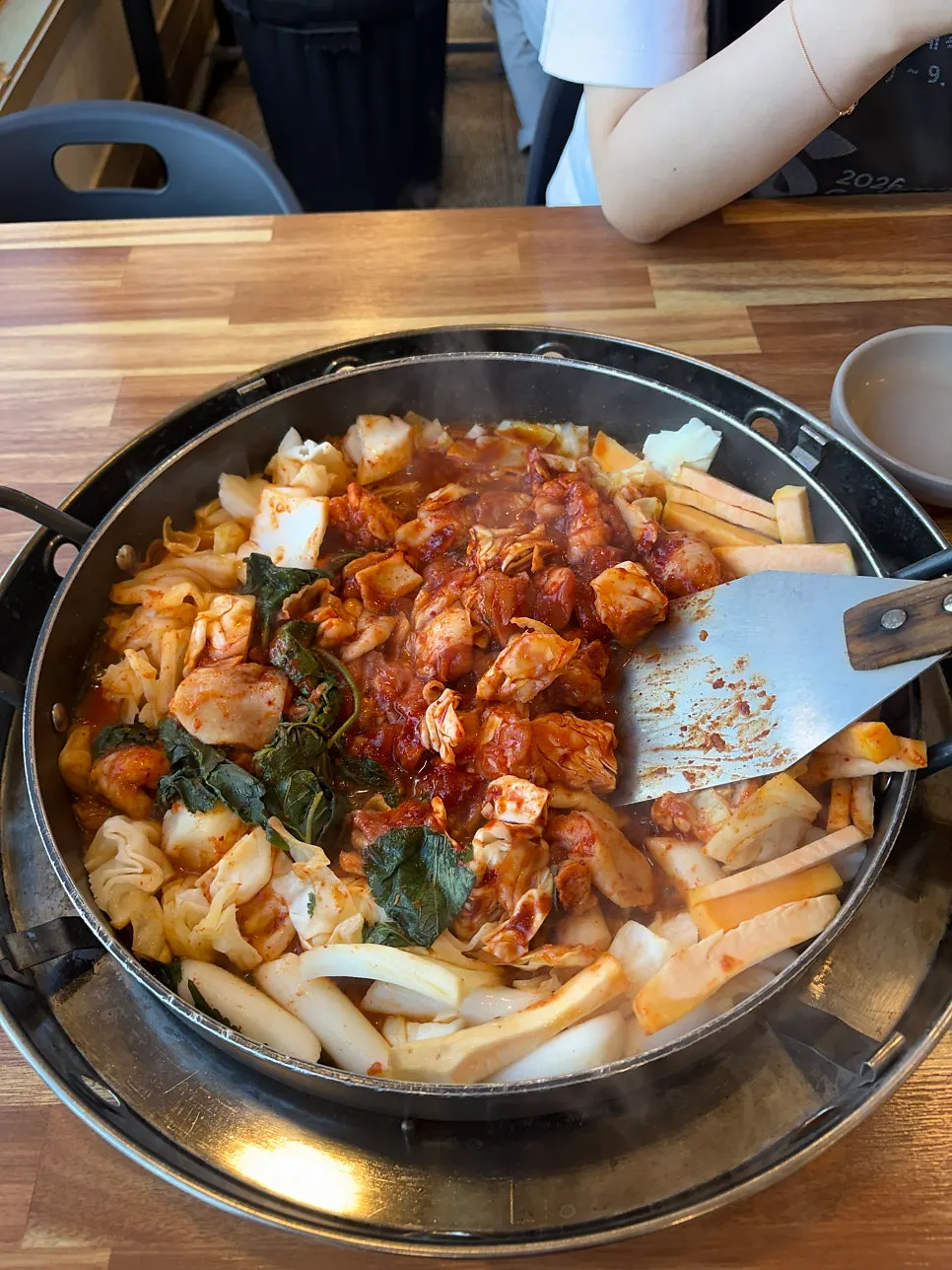 Dakgalbi for two set up on the pan with vegetables, rice cakes and sweet potato
