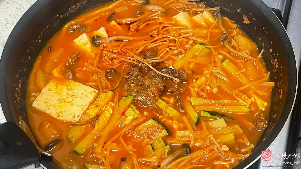 Spicy Korean beef tendon stew simmered with enoki mushrooms and tofu