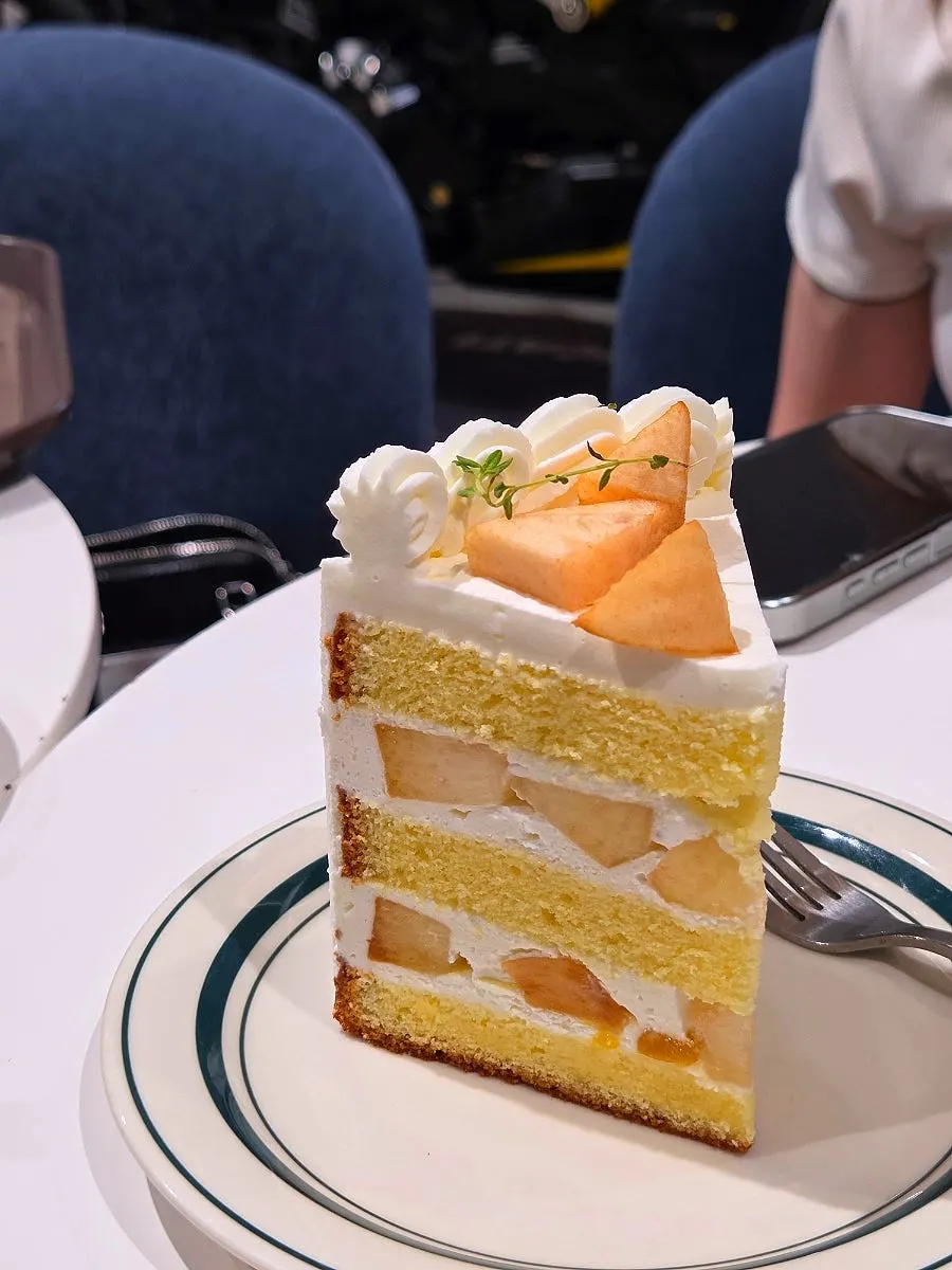 A seat with coffee and cake laid out together