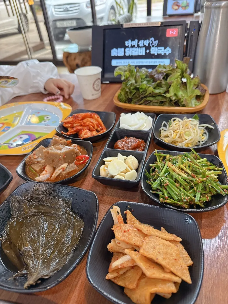 Signature deodeok-muchim and pickled radish side dishes